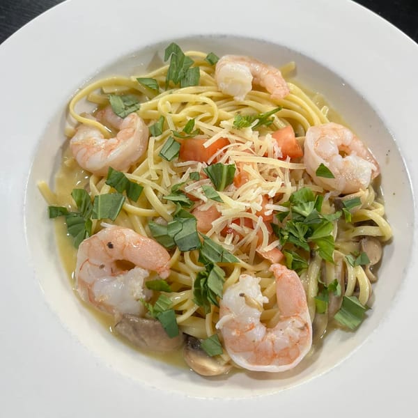 Casa Express shrimp scampi with linguine, mushrooms, tomatoes, basil, and grated cheese.