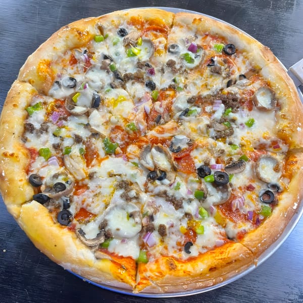 A Casa Express pizza with pepperoni, sausage, mushrooms, olives, green peppers, and red onions.